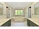 Bright bathroom with a soaking tub, natural light and dual vanity sinks at 12380 Creekwood Ln, Carmel, IN 46032