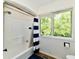 Bright bathroom featuring a shower/tub combo with large window at 12380 Creekwood Ln, Carmel, IN 46032