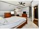 Comfortable bedroom boasts a mounted television and leads to the bathroom at 12380 Creekwood Ln, Carmel, IN 46032