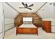 Spacious bedroom features a wooden accent wall, ceiling fan, and neutral carpet at 12380 Creekwood Ln, Carmel, IN 46032