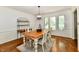 Formal dining room boasts natural light, classic chandelier, and decorative molding at 12380 Creekwood Ln, Carmel, IN 46032