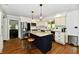 Well-equipped kitchen features white cabinets, a center island with seating, and stainless steel appliances at 12380 Creekwood Ln, Carmel, IN 46032