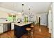 Spacious kitchen featuring a center island with stools and an adjacent dining area at 12380 Creekwood Ln, Carmel, IN 46032