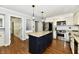 Bright kitchen features stainless steel appliances, an island, and granite countertops at 12380 Creekwood Ln, Carmel, IN 46032
