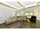 Bright living room with coffered ceilings, recessed lighting, and views of the wooded backyard at 12380 Creekwood Ln, Carmel, IN 46032