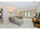 Cozy living room features a comfortable sectional and ample natural light at 12380 Creekwood Ln, Carmel, IN 46032