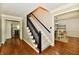 Spacious foyer features a staircase with dark handrail and views into other rooms at 12380 Creekwood Ln, Carmel, IN 46032