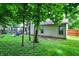 Spacious backyard featuring lush green grass, mature trees, a charming pergola, and well-maintained landscaping for outdoor enjoyment at 1264 Black Oak Dr, Greenwood, IN 46143
