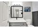 Bathroom featuring a large mirror, stylish lighting, white cabinets and countertops, and modern accents at 1264 Black Oak Dr, Greenwood, IN 46143