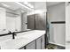 Well-lit bathroom with a gray vanity, black hardware, a framed mirror, and tiled floors at 1264 Black Oak Dr, Greenwood, IN 46143