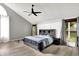 This bedroom features an attractive ceiling fan, hardwood floors, and a window with a view of the outdoors at 1264 Black Oak Dr, Greenwood, IN 46143