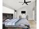 Primary bedroom with light hardwood floors, TV, and a barn door to the bathroom at 1264 Black Oak Dr, Greenwood, IN 46143
