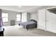 Spacious bedroom with neutral walls, carpet flooring, and a bed near three closets at 1264 Black Oak Dr, Greenwood, IN 46143