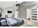 This primary bedroom has a ceiling fan, hardwood floors, and a sliding door that leads to an en suite bathroom at 1264 Black Oak Dr, Greenwood, IN 46143