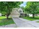 Beautiful two-story home featuring green shutters, a two-car garage, and a large front yard with mature trees at 1264 Black Oak Dr, Greenwood, IN 46143