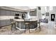 The kitchen has a stone backsplash, white countertops, hardwood floors and a view of the Gathering room at 1264 Black Oak Dr, Greenwood, IN 46143