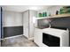 A modern laundry room with new gray paint, new washer and dryer and new tile floor at 1264 Black Oak Dr, Greenwood, IN 46143
