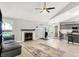 Spacious living room with a fireplace, ceiling fan, and an open floor plan with light hardwood style flooring at 1264 Black Oak Dr, Greenwood, IN 46143