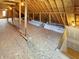 Spacious unfinished attic with plywood subfloor and a bright window, perfect for storage or finishing at 1412 10Th St, Danville, IN 46122