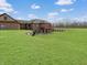 Lush backyard with a brick home featuring a cozy wooden deck perfect for outdoor relaxation and entertainment at 1412 10Th St, Danville, IN 46122