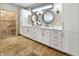 Elegant bathroom with dual sinks, white cabinetry, decorative mirrors, and a tiled walk-in shower at 1412 10Th St, Danville, IN 46122