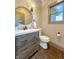 Charming bathroom featuring a rustic vanity, round mirror, and elegant fixtures, filled with natural light at 1412 10Th St, Danville, IN 46122