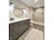 Modern bathroom featuring sleek vanity with gold accents, shower with tile surround at 1412 10Th St, Danville, IN 46122