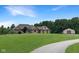 Charming brick home featuring a large front lawn, complemented by a shed with a matching roof at 1412 10Th St, Danville, IN 46122