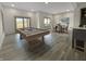Entertaining game room with a pool table, dining area, and sliding glass doors to the outdoors at 1412 10Th St, Danville, IN 46122