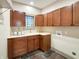 Functional laundry room with ample cabinet space, a sink, and a window for natural light at 1412 10Th St, Danville, IN 46122