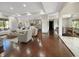 Spacious living room with dark wood floors leading to an open-concept kitchen and staircase at 1412 10Th St, Danville, IN 46122