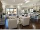 Open-concept living room with stylish white sofas and a view of the modern kitchen at 1412 10Th St, Danville, IN 46122