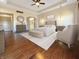 Serene main bedroom with neutral tones, wood floors, a ceiling fan, and an ensuite bathroom entrance at 1412 10Th St, Danville, IN 46122
