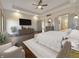 Serene main bedroom with a ceiling fan, and an ensuite bathroom entrance and entertainment center at 1412 10Th St, Danville, IN 46122