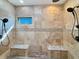 Custom tiled shower features dual shower heads, built-in bench seating, and a window for natural light at 1412 10Th St, Danville, IN 46122
