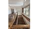 Beautiful staircase features hardwood steps, iron spindles, and abundant natural light from large windows at 1412 10Th St, Danville, IN 46122