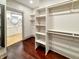 Walk-in closet has ample storage with shelves and rods, and includes an adjoining bathroom at 1412 10Th St, Danville, IN 46122