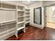 Spacious walk-in closet includes custom shelving, a full-length mirror, and hardwood flooring at 1412 10Th St, Danville, IN 46122