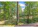 Enjoy a fire in the backyard, featuring towering trees and a glimpse of the pond at 1413 N Lost Lake Rd, Columbus, IN 47201
