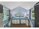 Cozy bedroom featuring cool blue walls and patterned bedding with natural light at 1413 N Lost Lake Rd, Columbus, IN 47201
