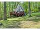 A-frame cabin featuring a spacious deck and beautiful wooded surroundings, perfect for relaxation at 1413 N Lost Lake Rd, Columbus, IN 47201