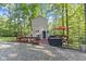 A-frame home with wooded backdrop, showing outdoor deck, seating, and lake access at 1413 N Lost Lake Rd, Columbus, IN 47201