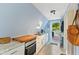 Compact kitchen space with modern appliances and granite countertops, leading to an outdoor area at 1413 N Lost Lake Rd, Columbus, IN 47201