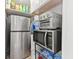 This pantry features stainless steel appliances and convenient storage solutions at 1413 N Lost Lake Rd, Columbus, IN 47201