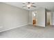 Bedroom features a ceiling fan, neutral walls, and carpet floors with a view into the bathroom at 15523 Follow Dr, Noblesville, IN 46060