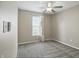 Cozy bedroom with soft carpeting, a ceiling fan, and a bright window with patterned curtains at 15523 Follow Dr, Noblesville, IN 46060
