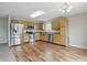 Eat-in kitchen featuring stainless steel appliances, wooden cabinetry, and laminate flooring at 15523 Follow Dr, Noblesville, IN 46060