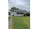 View of the front of the house with a driveway leading to a detached garage at 1609 N Outer Dr, Lebanon, IN 46052