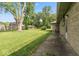 Lush backyard featuring expansive green space, mature trees, and stone-detailed home exterior at 1613 Park Rd, Anderson, IN 46011