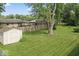 Spacious backyard featuring a shed, large trees, and a well-maintained lawn at 1613 Park Rd, Anderson, IN 46011